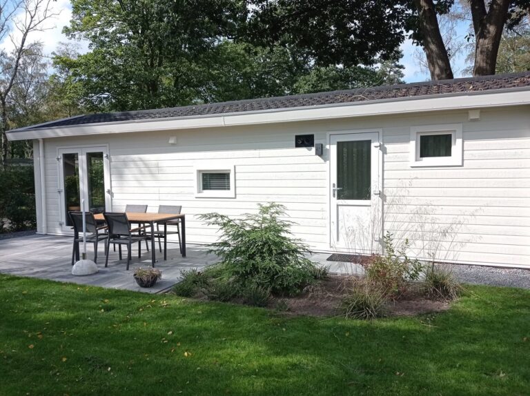 White cabin with outdoor seating