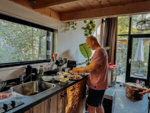 4 Person Holiday Home Near Arnhem Man preparing food in kitchen